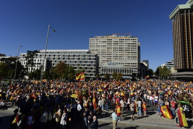 La gente agita banderas españolas durante una manifestación llamando a la unidad en la Plaza de Colón en Madrid el 28 de octubre de 2017, un día después de que se impuso el control directo sobre Cataluña en un intento por separarse de España. España se movió para afirmar el dominio directo sobre Cataluña, reemplazando a sus funcionarios ejecutivos y altos para sofocar un impulso de independencia que ha sumido al país en una crisis y ha puesto nerviosa a la Europa secesionista. / AFP PHOTO / JAVIER SORIANO