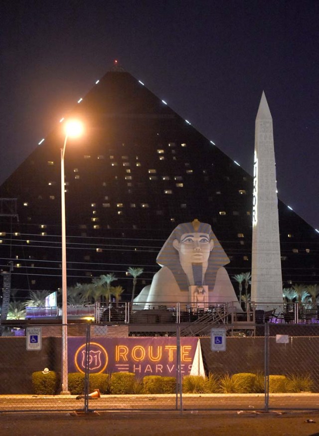 LAS VEGAS, NV - OCTOBER 02: A banner hangs on the fence in the shadow of the Luxor Hotel & Casino at the Route 91 Harvest country music festival grounds after a active shooter was reported on October 2, 2017 in Las Vegas, Nevada. A gunman has opened fire on a music festival in Las Vegas, leaving at least 20 people dead and more than 100 injured. Police have confirmed that one suspect has been shot. The investigation is ongoing. David Becker/Getty Images/AFP