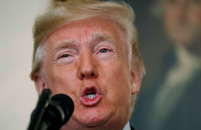 U.S. President Donald Trump makes a statement on the mass shooting in Las Vegas in front of a portrait of President George Washington in the Diplomatic Room at the White House in Washington, U.S., October 2, 2017. REUTERS/Kevin Lamarque