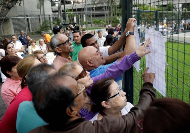 Venezuela's citizens check lists in a polling station during a nationwide election for new governors in Caracas, Venezuela, October 15, 2017. REUTERS/Ricardo Moraes