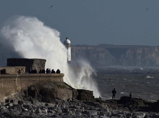 Waves crash over the lighthouse as storm Ophelia approaches Porthcawl, Wales, Britain October 16, 2017. REUTERS/Rebecca Naden