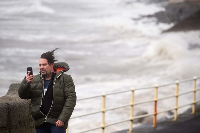 A man takes a selfie during storm Ophelia in the County Clare town of Lahinch, Ireland October 16, 2017. REUTERS/Clodagh Kilcoyne