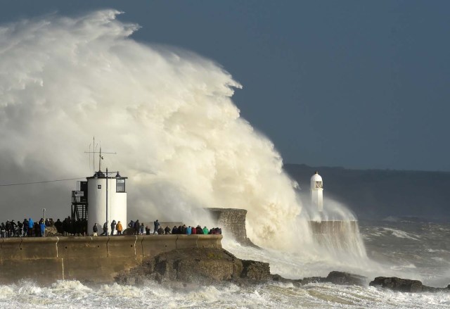 Waves crash over the lighthouse as storm Ophelia passes Porthcawl, Wales, Britain, October 16, 2017. REUTERS/Rebecca Naden
