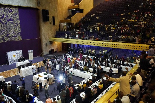 Zimbabwean Senators and Members of Parliament react after the resignation of Zimbabwe's president Robert Mugabe on November 21, 2017, during a general session of parliament and senate at the Rainbow Tower Conference Center in Harare. Robert Mugabe resigned as president of Zimbabwe on November 21, 2017, ending a 37-year rule defined by brutality and economic collapse. / AFP PHOTO / Marco Longari