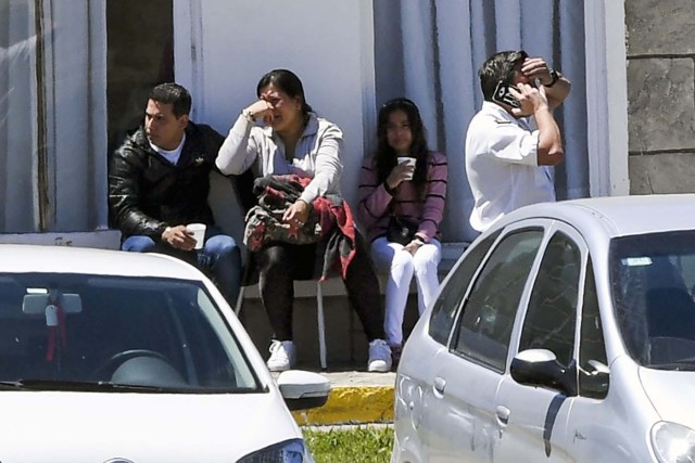 Relatives and comrades of 44 crew members of Argentine missing submarine, express their grief at Argentina's Navy base in Mar del Plata, on the Atlantic coast south of Buenos Aires, on November 23, 2017. An unusual noise heard in the ocean near the last known position of the San Juan submarine was "consistent with an explosion," Argentina's navy announced Thursday. "An anomalous, singular, short, violent and non-nuclear event consistent with an explosion," occurred shortly after the last communication of the San Juan and its 44 crew, navy spokesman Captain Enrique Baldi told a news conference in Buenos Aires. / AFP PHOTO / EITAN ABRAMOVICH / BEST QUALITY AVAILABLE