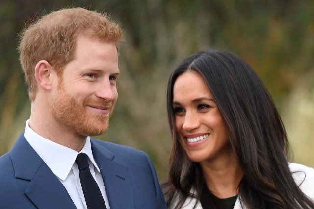 Britain's Prince Harry poses with Meghan Markle in the Sunken Garden of Kensington Palace, London, Britain, November 27, 2017. REUTERS/Toby Melville