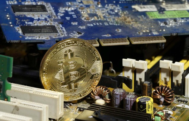 FILE PHOTO: A copy of bitcoin standing on PC motherboard is seen in this illustration picture, October 26, 2017.   REUTERS/Dado Ruvic/File Photo