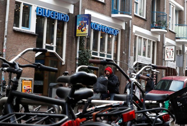 A cyclist rides past a coffee shop in central Amsterdam, Netherlands, December 1, 2017. REUTERS/Yves Herman