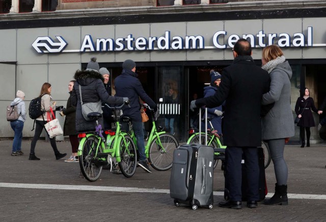 People walk near rental bicycles outside central station in Amsterdam, Netherlands, December 1, 2017. REUTERS/Yves Herman