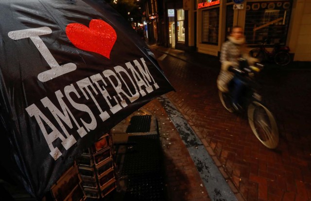 A cyclist rides past a touristic shop in the red district of Amsterdam, Netherlands, November 30, 2017. Picture taken November 30, 2017. REUTERS/Yves Herman