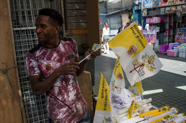 A street vendor offers merchandise of Pope Francis before the pontiff's upcoming visit to Chile, in Santiago, on January 8, 2018. Pope Francis will be visiting Chile from January 15 to 18. / AFP PHOTO / Martin BERNETTI