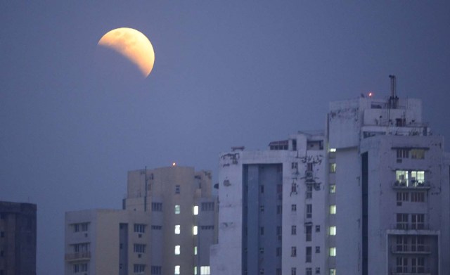 The moon is seen during a lunar eclipse referred to as the "super blue blood moon", in Kolkata on January 31, 2018. Skywatchers were hoping for a rare lunar eclipse that combines three unusual events -- a blue moon, a super moon and a total eclipse -- which was to make for a large crimson moon viewable in many corners of the globe / AFP PHOTO / Dibyangshu SARKAR