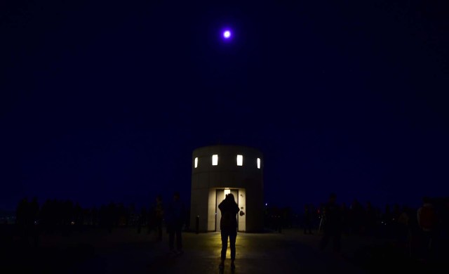 People attend the lunar eclipse celebration at Griffith Observatory in Los Angeles, California in the early hours of January 31, 2018, to witness the Super Blue Blood Moon, an event not seen since 1866 where three fairly common lunar happenings occur at the same time. Stargazers across large swathes of the globe -- from the streets of Los Angeles to the slopes of a smouldering Philippine volcano -- had the chance to witness a rare "super blue blood Moon" Wednesday, when Earth's shadow bathed our satellite in a coppery hue.The celestial show is the result of the Sun, Earth, and Moon lining up perfectly for a lunar eclipse just as the Moon is near its closest orbit point to Earth, making it appear "super" large. / AFP PHOTO / Frederic J. BROWN