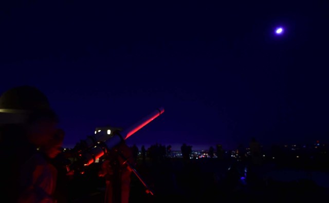 Telescopes are used for a closer view as people attend the lunar eclipse celebration at Griffith Observatory in Los Angeles, California in the early hours of January 31, 2018, to witness the Super Blue Blood Moon, an event not seen since 1866 when three fairly common lunar happenings occur at the same time. Stargazers across large swathes of the globe -- from the streets of Los Angeles to the slopes of a smouldering Philippine volcano -- had the chance to witness a rare "super blue blood Moon" Wednesday, when Earth's shadow bathed our satellite in a coppery hue.The celestial show is the result of the Sun, Earth, and Moon lining up perfectly for a lunar eclipse just as the Moon is near its closest orbit point to Earth, making it appear "super" large. / AFP PHOTO / Frederic J. BROWN