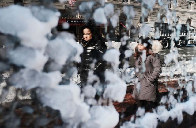 BOSTON, MA - JANUARY 05: People are reflected in a frozen window the morning after a massive winter storm on January 5, 2018 in Boston, United States. Schools and businesses throughout the Boston area get back to work today after the city received over a foot of snow during a fast moving storm yesterday. Spencer Platt/Getty Images/AFP