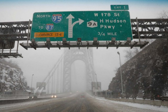 A nearly empty snow-covered roadway entrance to the George Washington Bridge between New Jersey and New York is seen during a snowstorm in Fort Lee, New Jersey, U.S., January 4, 2018. REUTERS/Mike Segar