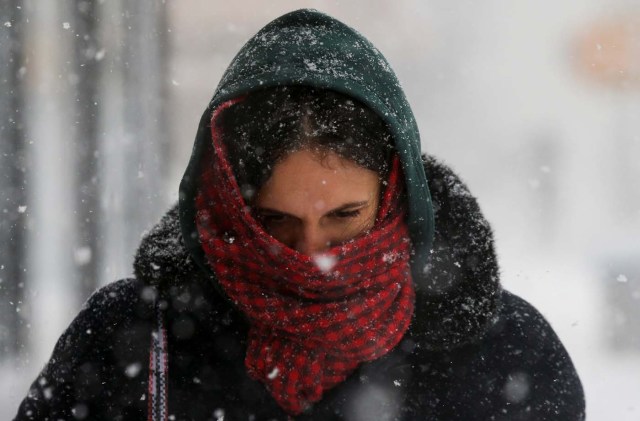 A woman struggles against wind and snow during a snowstorm in the Brooklyn borough of New York City, U.S., January 4, 2018. REUTERS/Brendan McDermid