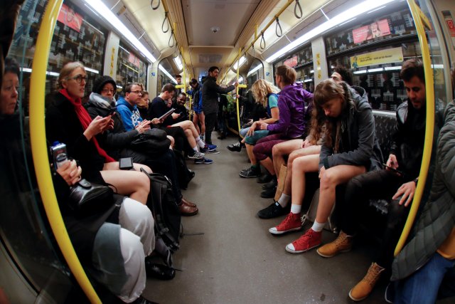 People take part in the annual flash mob "No Pants Subway Ride" in Berlin, Germany, January 7, 2018. Picture taken with a fish-eye lens. REUTERS/Hannibal Hanschke