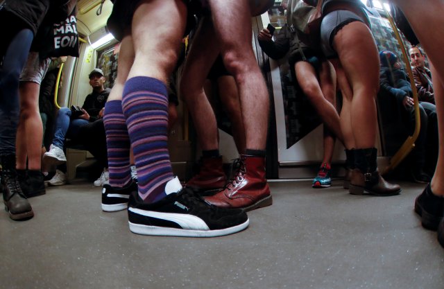 People take part in the annual flash mob "No Pants Subway Ride" in Berlin, Germany, January 7, 2018. Picture taken with a fish-eye lens. REUTERS/Hannibal Hanschke