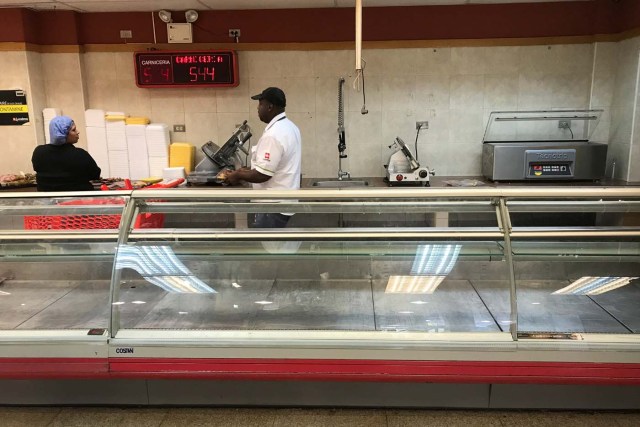 An empty refrigerator is seen at the butchery area in a supermarket in Caracas, Venezuela January 9, 2018. REUTERS/Marco Bello