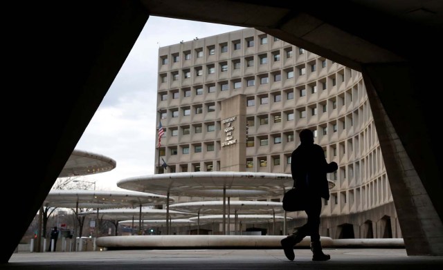 A pedestrian passes the Department of Housing and Urban Developement at the start of the third day of a shut down of the federal government in Washington, U.S., January 22, 2018.      REUTERS/Joshua Roberts