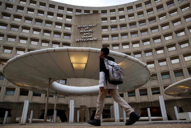 A pedestrian passes the Department of Housing and Urban Developement at the start of the third day of a shut down of the federal government in Washington, U.S., January 22, 2018. REUTERS/Joshua Roberts