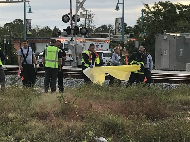 La policía de Boynton Beach se prepara para cubrir el cuerpo de un ciclista que fue golpeado por un tren. (George Bennett / The Palm Beach Post)