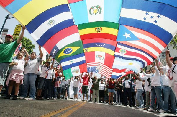 LOS ANGELES - JUNE 24:  A composite of numerous flags from across the world is held by immigrant reform supporters as they march on Hollywood Boulevard in support of the legalization of millions of undocumented immigrants living in the United States June 24, 2007 in Los Angeles, California. Fire officials estimated the crowd in attendance was around three thousand people.  (Photo by J. Emilio Flores/Getty Images)