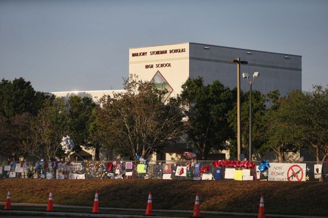 A general view of Marjory Stoneman Douglas High School as staff and teachers prepare for the return of students in Parkland, Florida on February 27, 2018. Florida's Marjory Stoneman Douglas high school will reopen on February 28, 2018 two weeks after 17 people were killed in a shooting by former student, Nikolas Cruz, leaving 17 people dead and 15 injured on February 14, 2018. / AFP PHOTO / RHONA WISE