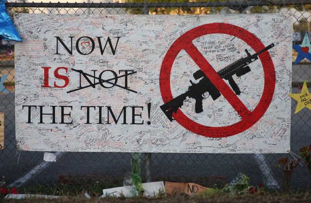 A sign hangs on a fence one at Marjory Stoneman Douglas High School in Parkland, Florida on February 27, 2018. Florida's Marjory Stoneman Douglas high school will reopen on February 28, 2018 two weeks after 17 people were killed in a shooting by former student, Nikolas Cruz, leaving 17 people dead and 15 injured on February 14, 2018. / AFP PHOTO / RHONA WISE