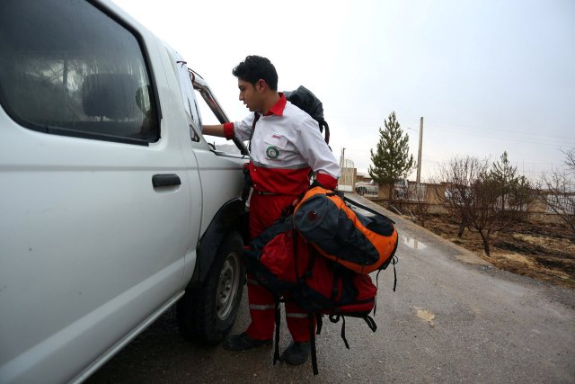 A medic is seen following a plane crash near the town of Semirom, Iran, February 18, 2017. REUTERS/Tasnim News Agency ATTENTION EDITORS - THIS PICTURE WAS PROVIDED BY A THIRD PARTY.