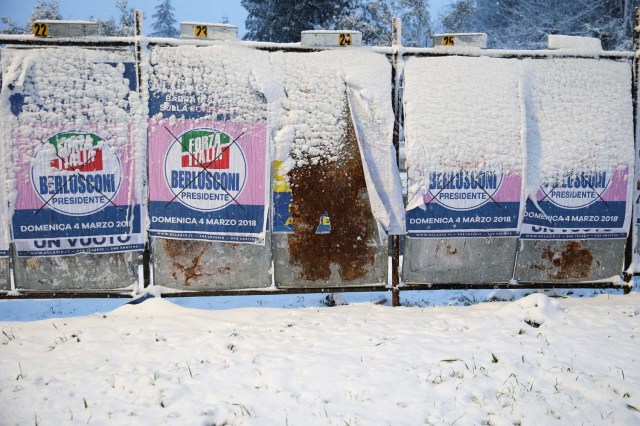 Electoral posters are seen during a heavy snowfall in Rome, Italy February 26, 2018. REUTERS/Max Rossi