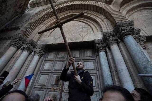 Peregrinos cristianos rezan ante la Iglesia del Santo Sepulcro en el casco viejo de Jerusalén, hoy, 27 de febrero de 2018. Las principales Iglesias cristianas en Jerusalén decidieron cerrar el pasado 25 de febrero el Santo Sepulcro, el lugar más sagrado del cristianismo, en una medida sin precedentes en protesta por medidas legales y fiscales de Israel que consideran un "ataque contra la presencia cristiana en Tierra Santa". EFE/ Atef Safadi