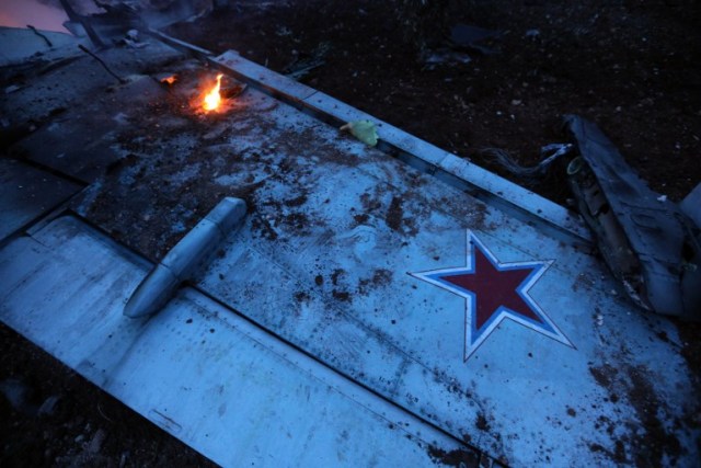 A picture taken on February 3, 2018, shows the wing of a downed Sukhoi-25 fighter jet near the Syrian city of Saraqib, southwest of Aleppo. Rebel fighters shot down a Russian plane over Syria's northwest Idlib province and captured its pilot, the Syrian Observatory for Human Rights said. / AFP PHOTO / OMAR HAJ KADOUR