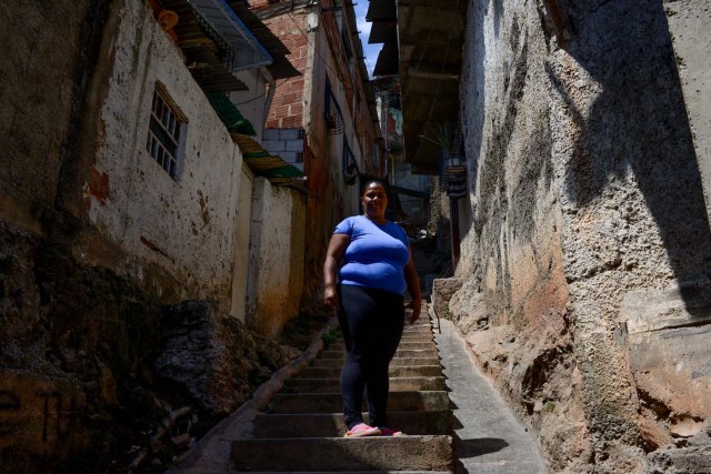 (FILES) In this file photo taken on February 28, 2018 Gabriela Vega, 35, community leader and cook poses for a picture at La Vega shantytown in Caracas. / AFP PHOTO / FEDERICO PARRA