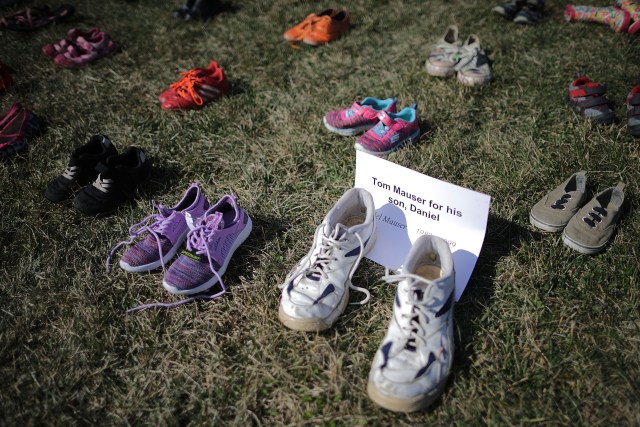 WASHINGTON, DC - MARCH 13: Seven thousand pairs of shoes, representing the children killed by gun violence since the mass shooting at Sandy Hook Elementary School in 2012, are spread out on the lawn on the east side of the U.S. Capitol March 13, 2018 in Washington, DC. Organized by the online activist group Avaaz, the shoes are intended to urge Congress to pass gun-reform legislation. Chip Somodevilla/Getty Images/AFP