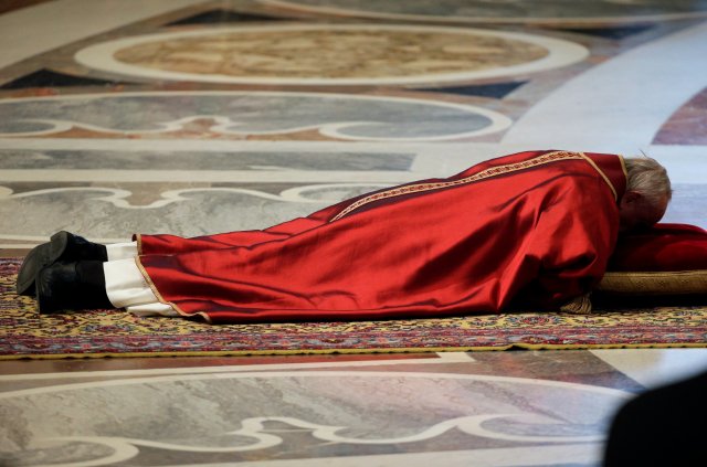 Pope Francis lies on the floor during the Good Friday Passion of the Lord Mass in Saint Peter's Basilica at the Vatican, March 30, 2018. REUTERS/Max Rossi