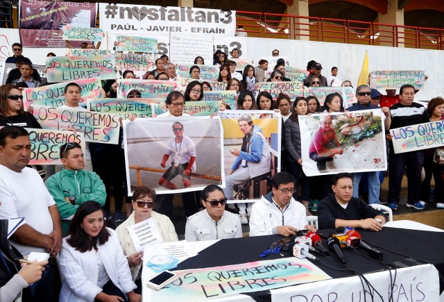 Relatives of journalists Javier Ortega and Paul Rivas and their driver Efrain Segarra, who are believed to be held by dissident Colombian rebels, reveal their names during a demonstration in Quito on April 1, 2018. The three, all working for the prominent Ecuadoran newspaper El Comercio, were seized early March 26 in the village of Mataje, in Esmeraldas province, according to officials. Ecuadoran Interior Minister Cesar Navas told journalists ahead of a meeting with relatives of the abducted on Saturday that "they were well, and the situation is stable."   / AFP PHOTO / Cristina VEGA