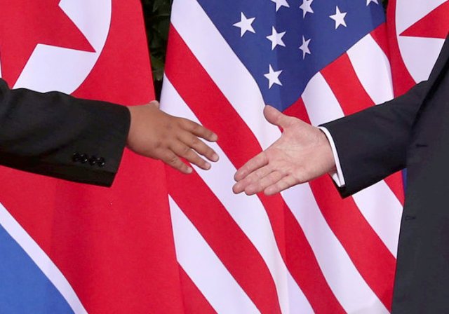 U.S. President Donald Trump shakes hands with North Korean leader Kim Jong Un at the Capella Hotel on Sentosa island in Singapore June 12, 2018. REUTERS/Jonathan Ernst